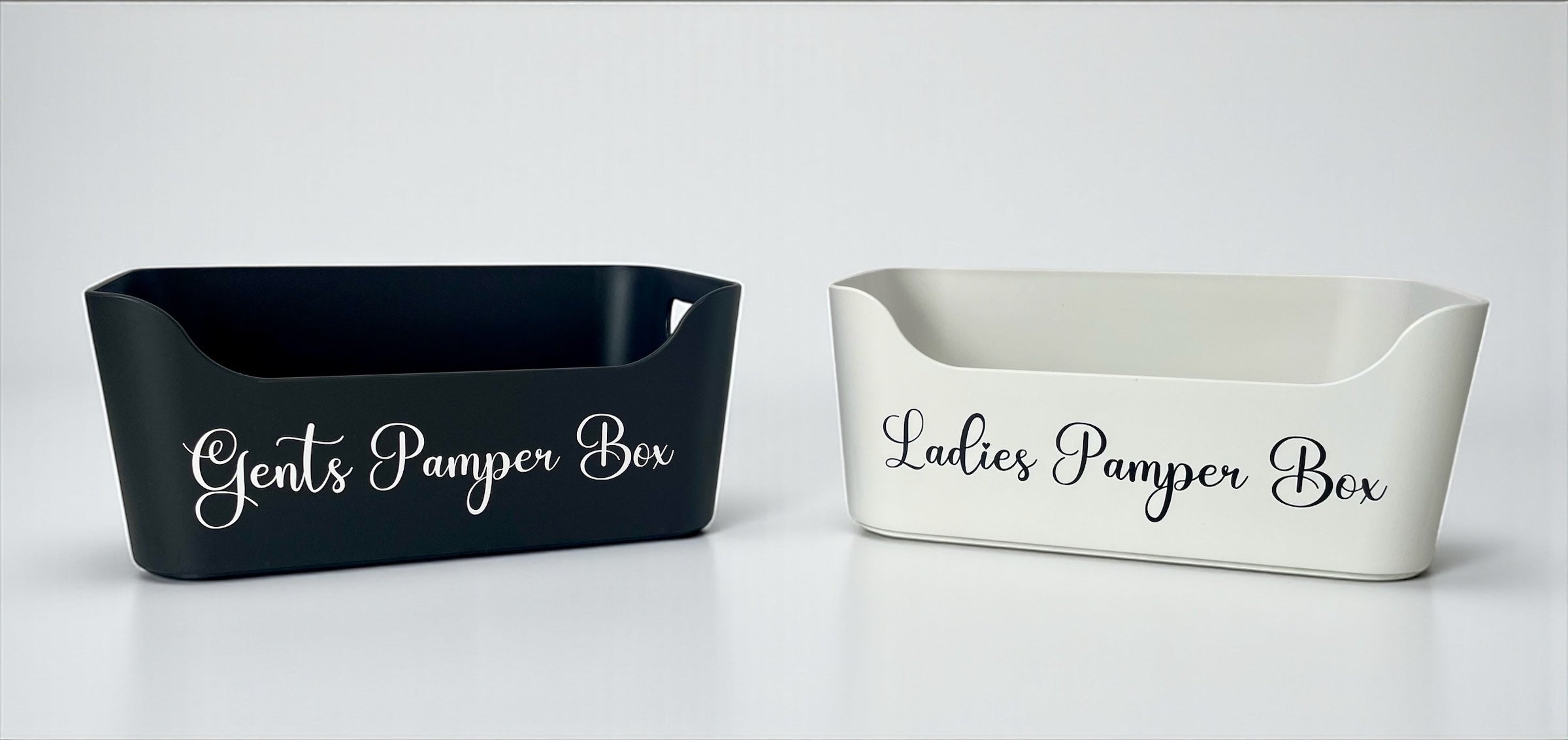Two rectangular containers labeled 'Gents Pamper Box' and 'Ladies Pamper Box' on a white background.