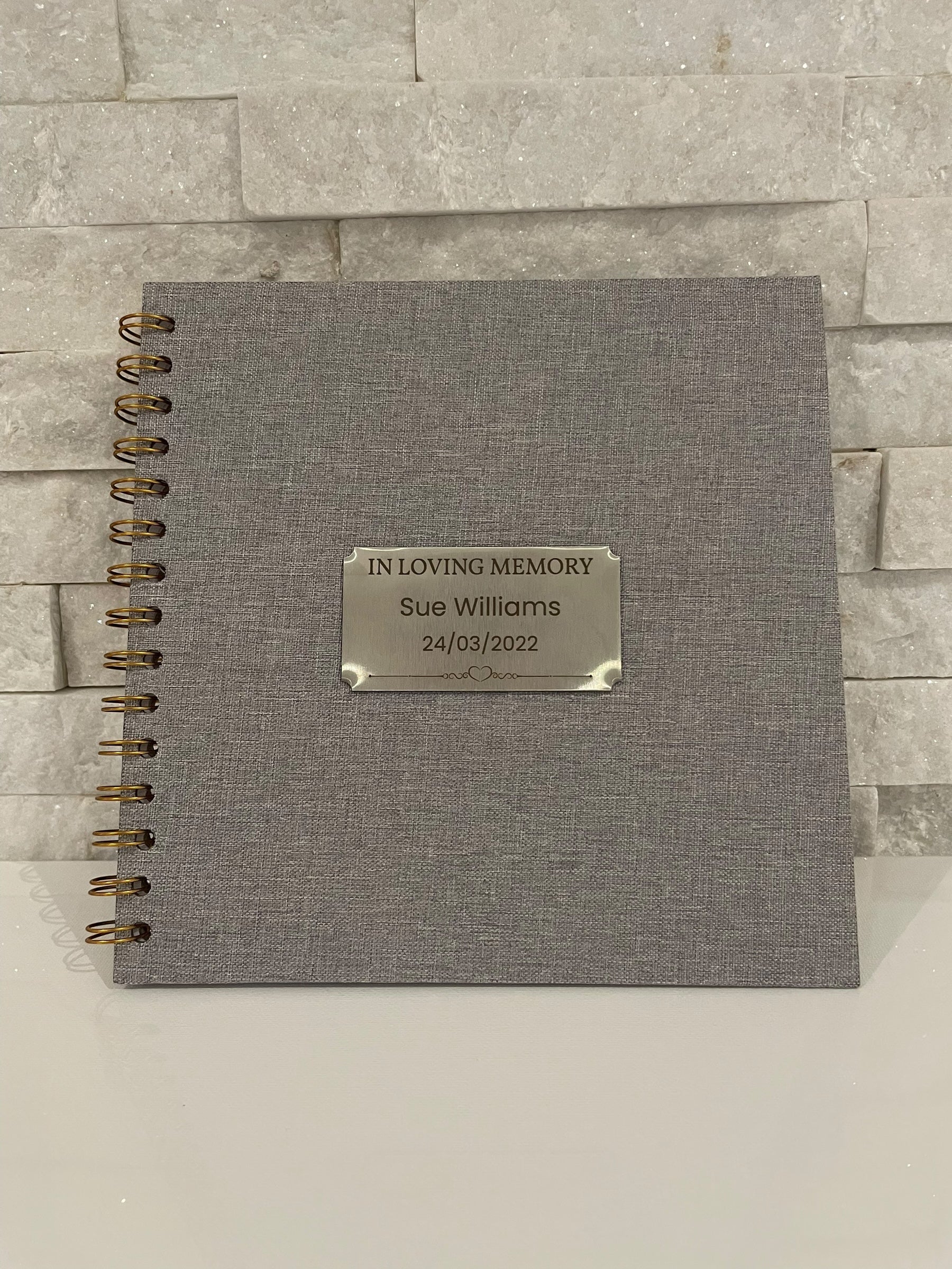 Personalised memorial scrapbook guest book with engraved plaque displaying name and date, shown as a funeral remembrance keepsake.